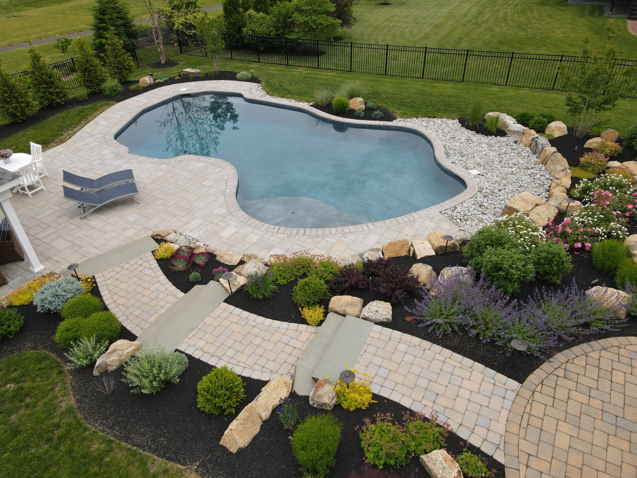 An ecoFINISH-coated pool showing the entire pool and the surrounding landscape.