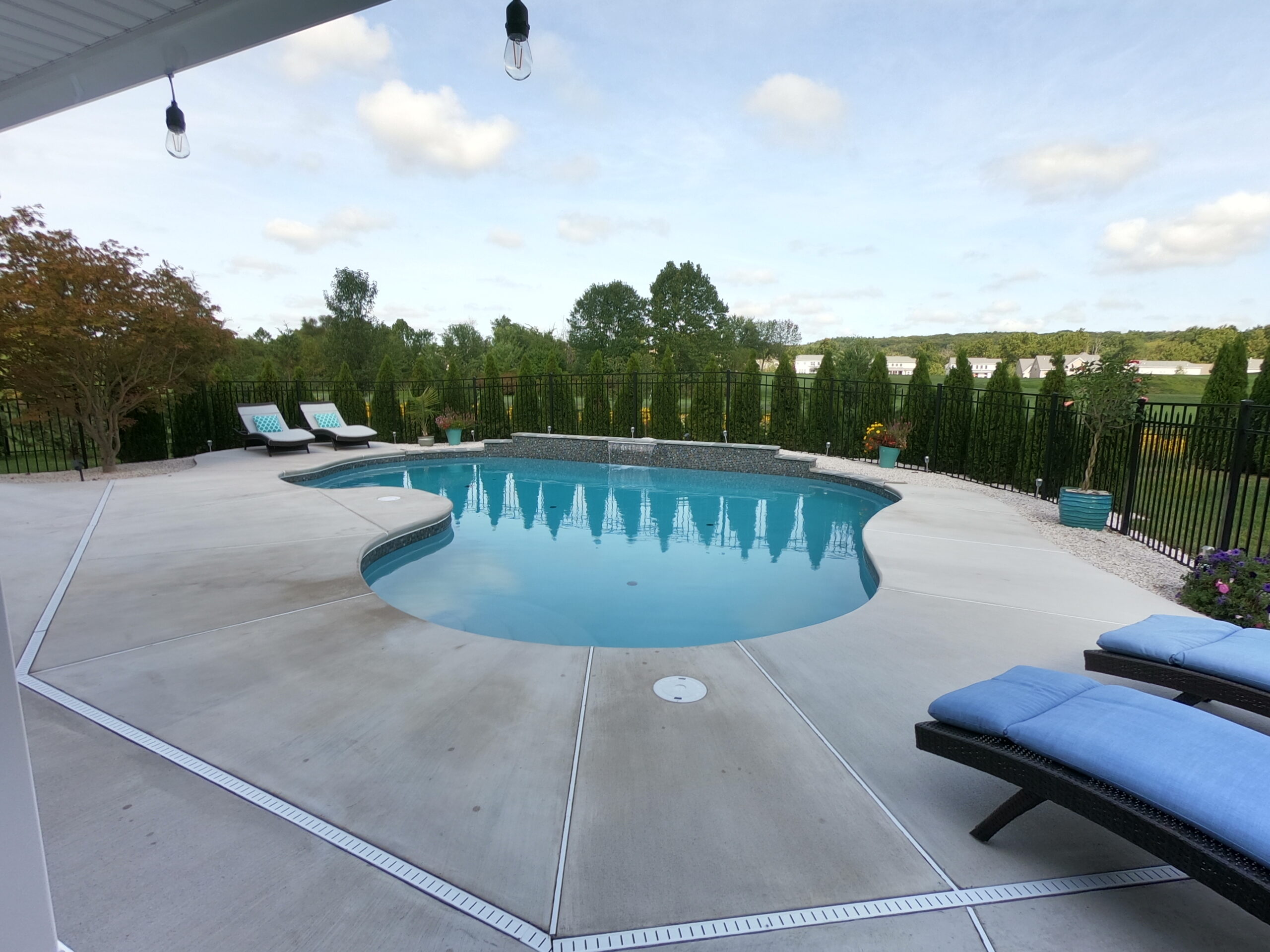 A low-angle view of an ecoFINISH-coated pool, highlighting the pool's surface and the surrounding landscape.