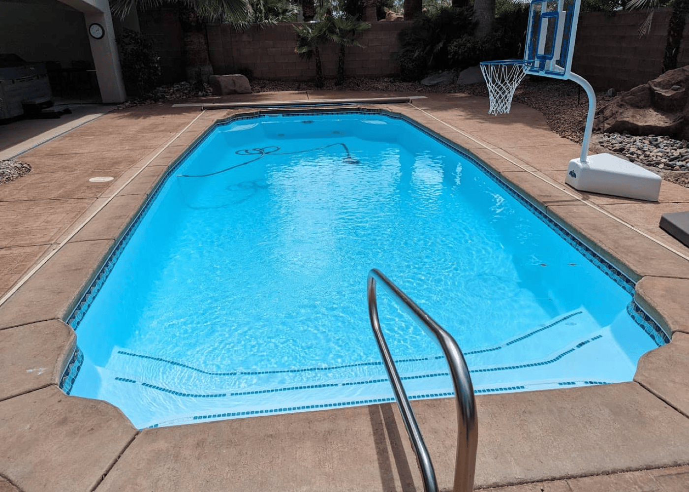 A filled in-ground pool viewed from a vertical angle.