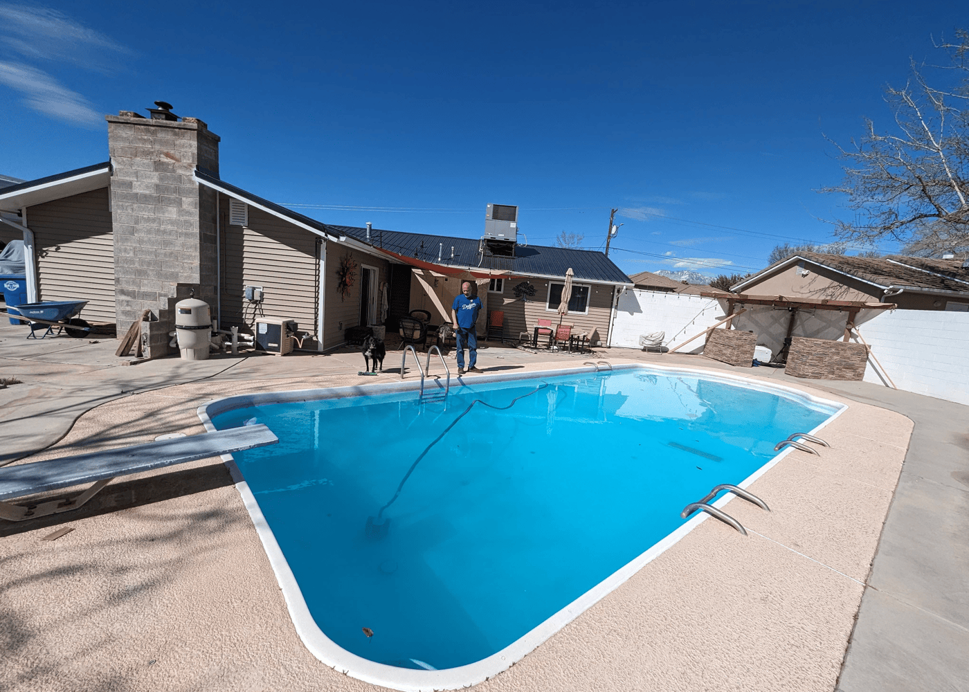 an in-ground pool filled with water, captured at an angle. With a robotic cleaner in the pool.