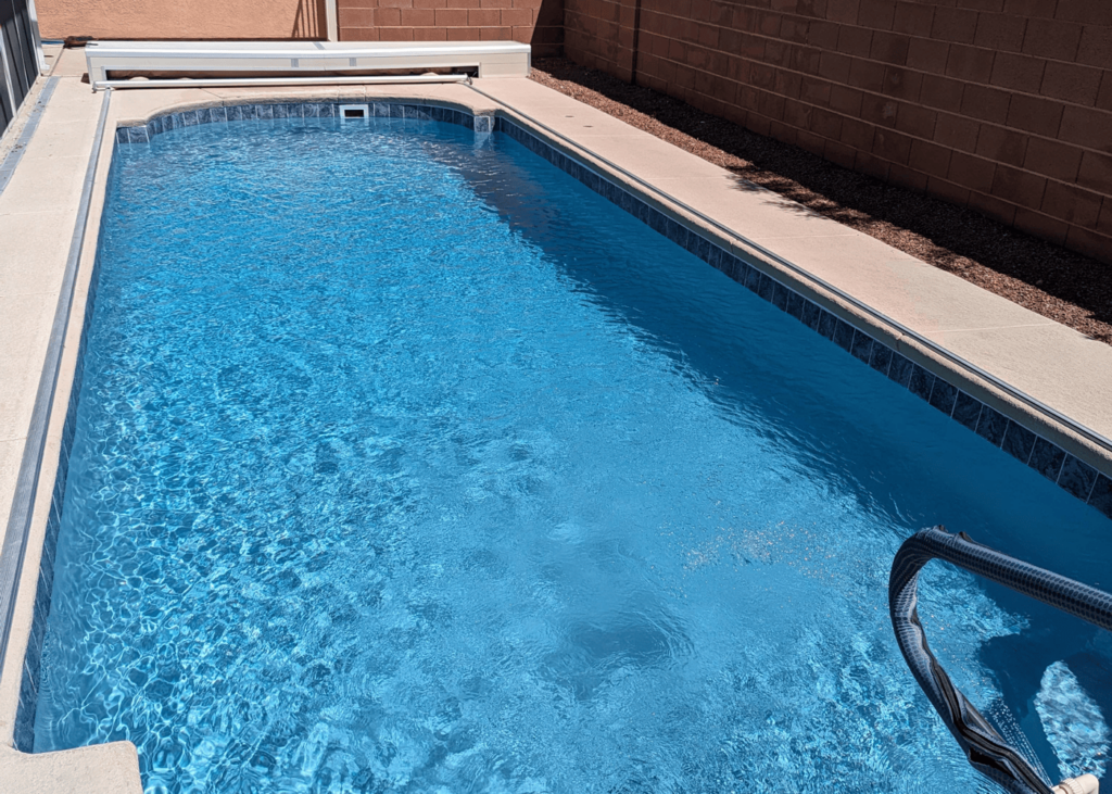 An in-ground pool filled with clear, sparkling water.