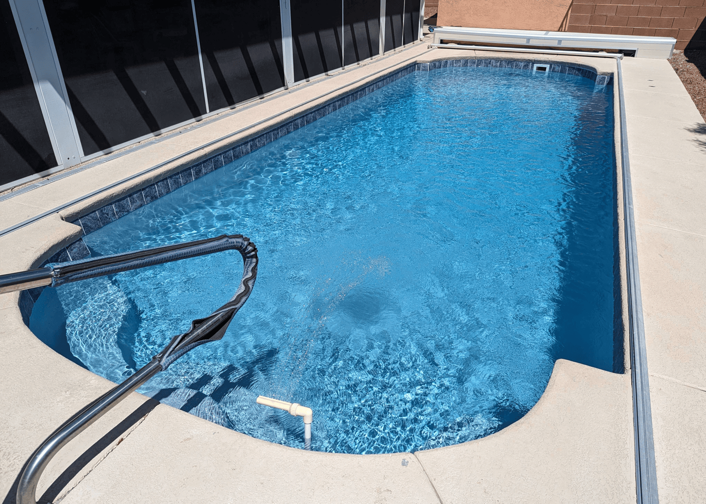 An in-ground pool filled with clear, sparkling water.